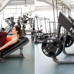 Kvinna tränar benpress i gym. Hon pressar vikter med benen på en Precor-maskin.