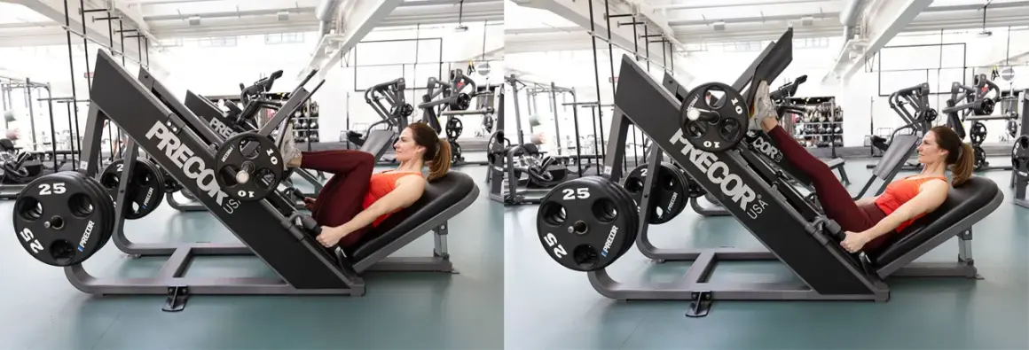 Kvinna tränar benpress i gym. Hon pressar vikter med benen på en Precor-maskin.