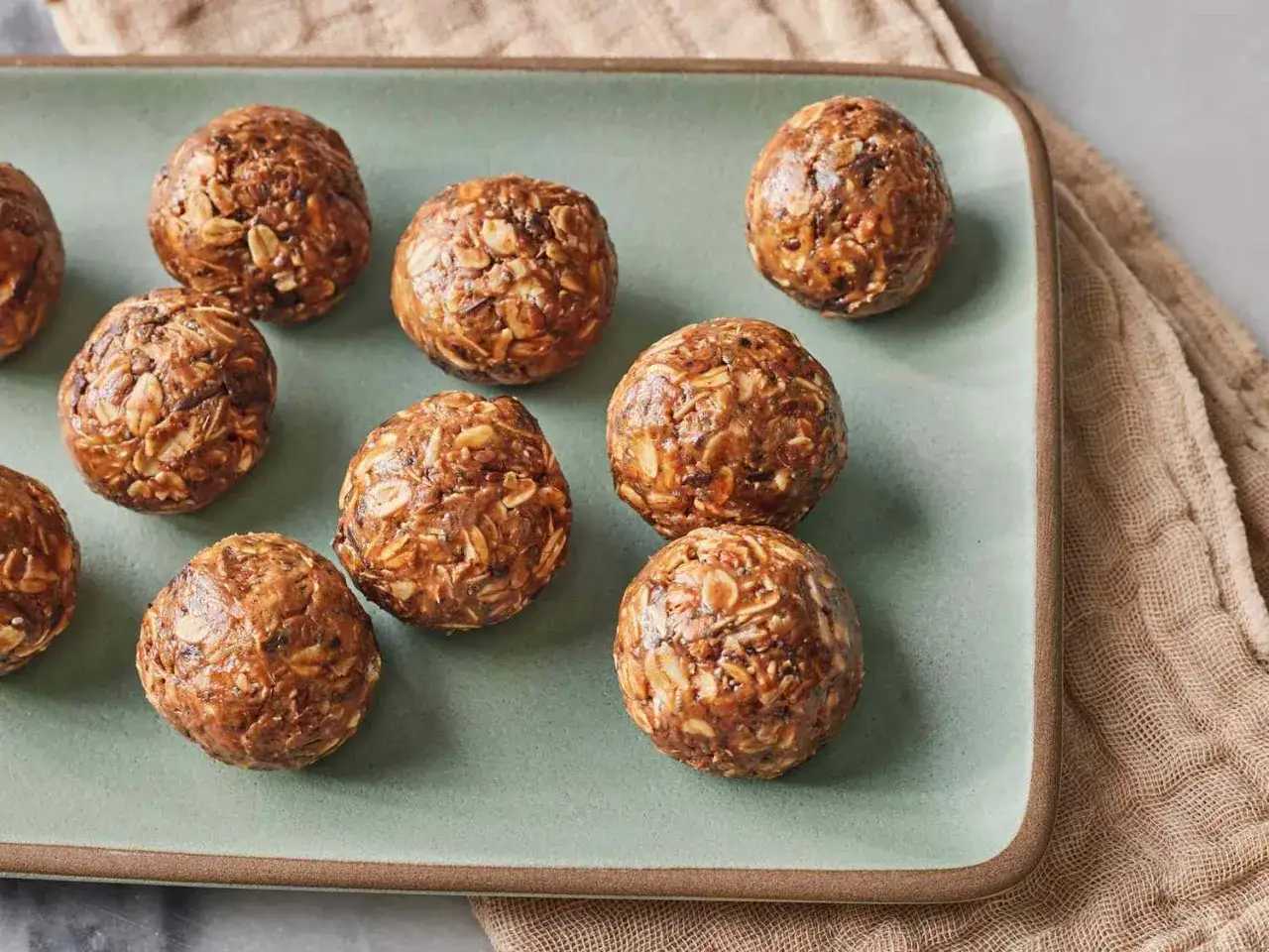 Flera protein chokladbollar ligger p&aring; ett fat. De ser goda och energigivande ut.