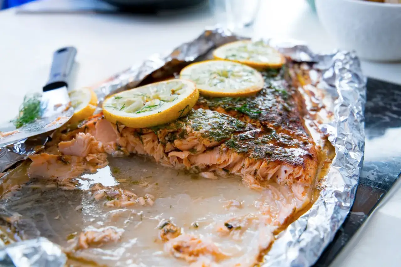 Saftig lax i ugnen, toppad med citron och dill. Perfekt tillagad och redo att serveras.